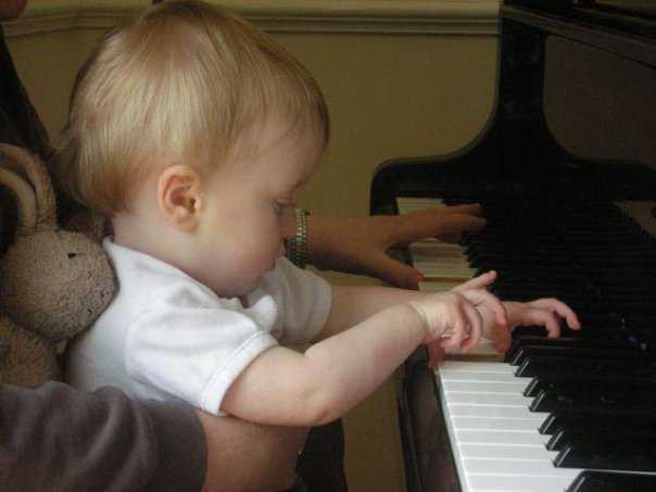 Alex taking piano lessons with his mother